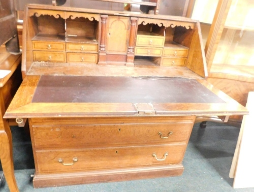 Appraisal: A George III oak and mahogany cross banded bureau the