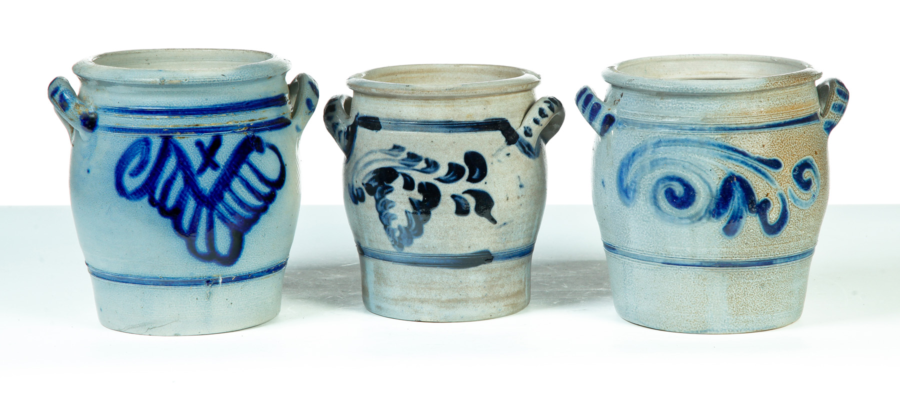 Appraisal: THREE GERMAN GRADUATED DOUBLE-HANDLED STONEWARE JARS Nineteenth century Salt glaze