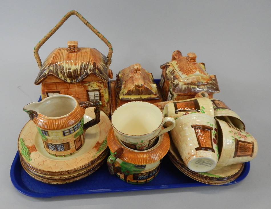 Appraisal: A quantity of Cottage ware to include a biscuit barrel