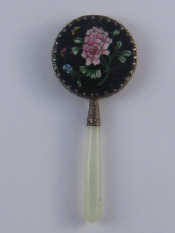 Appraisal: A small Chinese hand mirror with white hardstone handle and