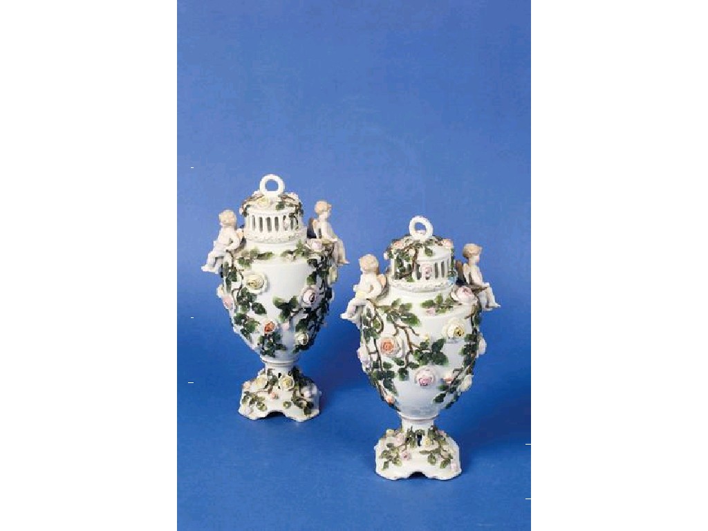 Appraisal: A PAIR OF DRESDEN TYPE VASES AND COVERS decorated in