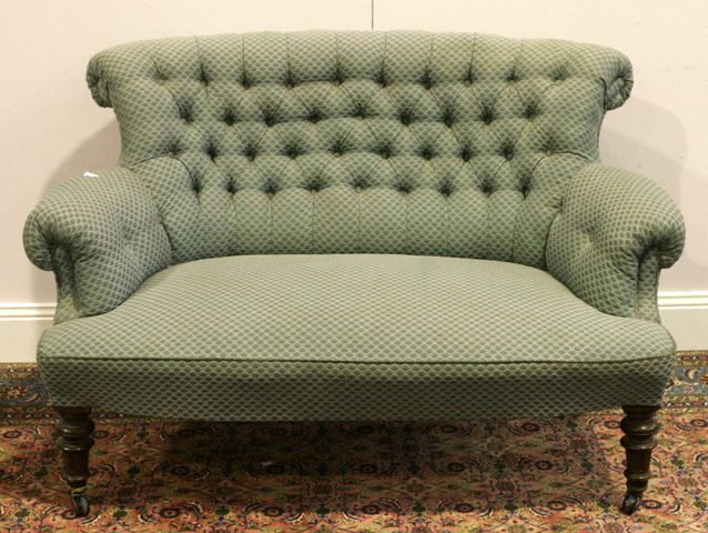 Appraisal: A Victorian mahogany and upholstered button back love seat