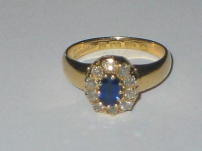 Appraisal: A SAPPHIRE AND DIAMOND CLUSTER RING with central oval cut