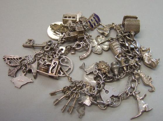 Appraisal: Two charm bracelets fitted with mostly silver charms including a