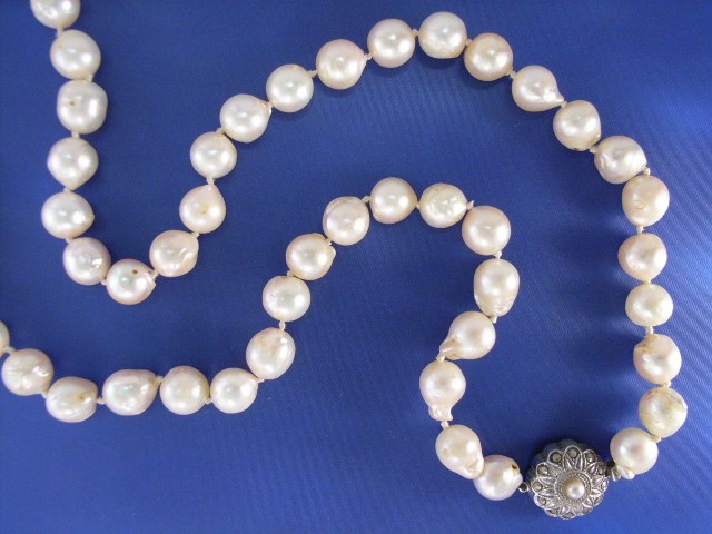 Appraisal: A mm cultured baroque pearl necklace with a silver clasp