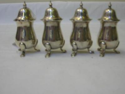 Appraisal: A SET OF FOUR EDWARDIAN PEPPERETTES of baluster form with