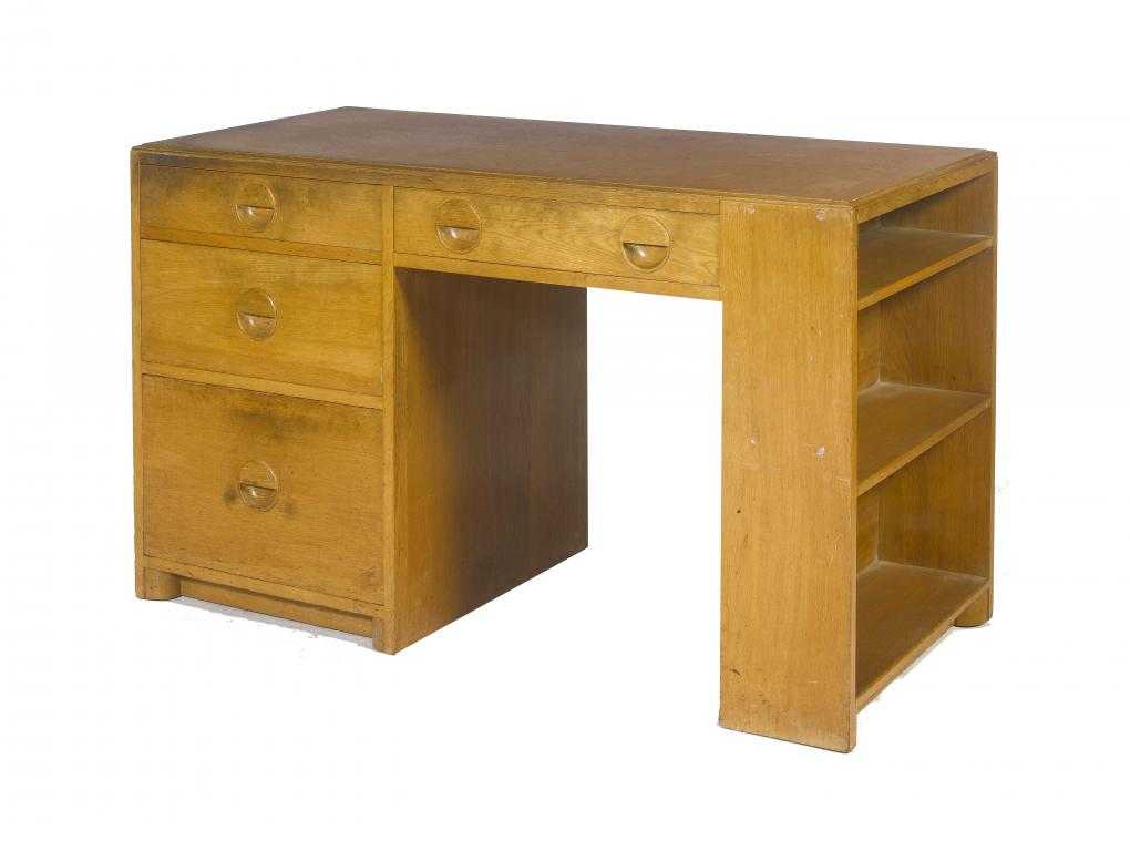 Appraisal: A MODERNIST OAK DESK BY DRUCE CO with chamfered quarter