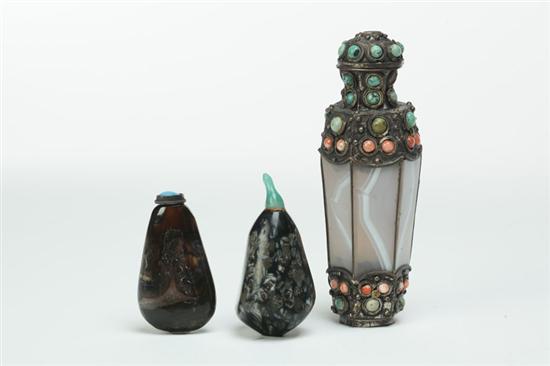 Appraisal: THREE SNUFF BOTTLES China th century Two of dark stone