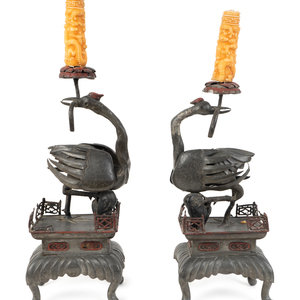 Appraisal: A Pair of Asian Metal Candlestands TH TH CENTURY depicting