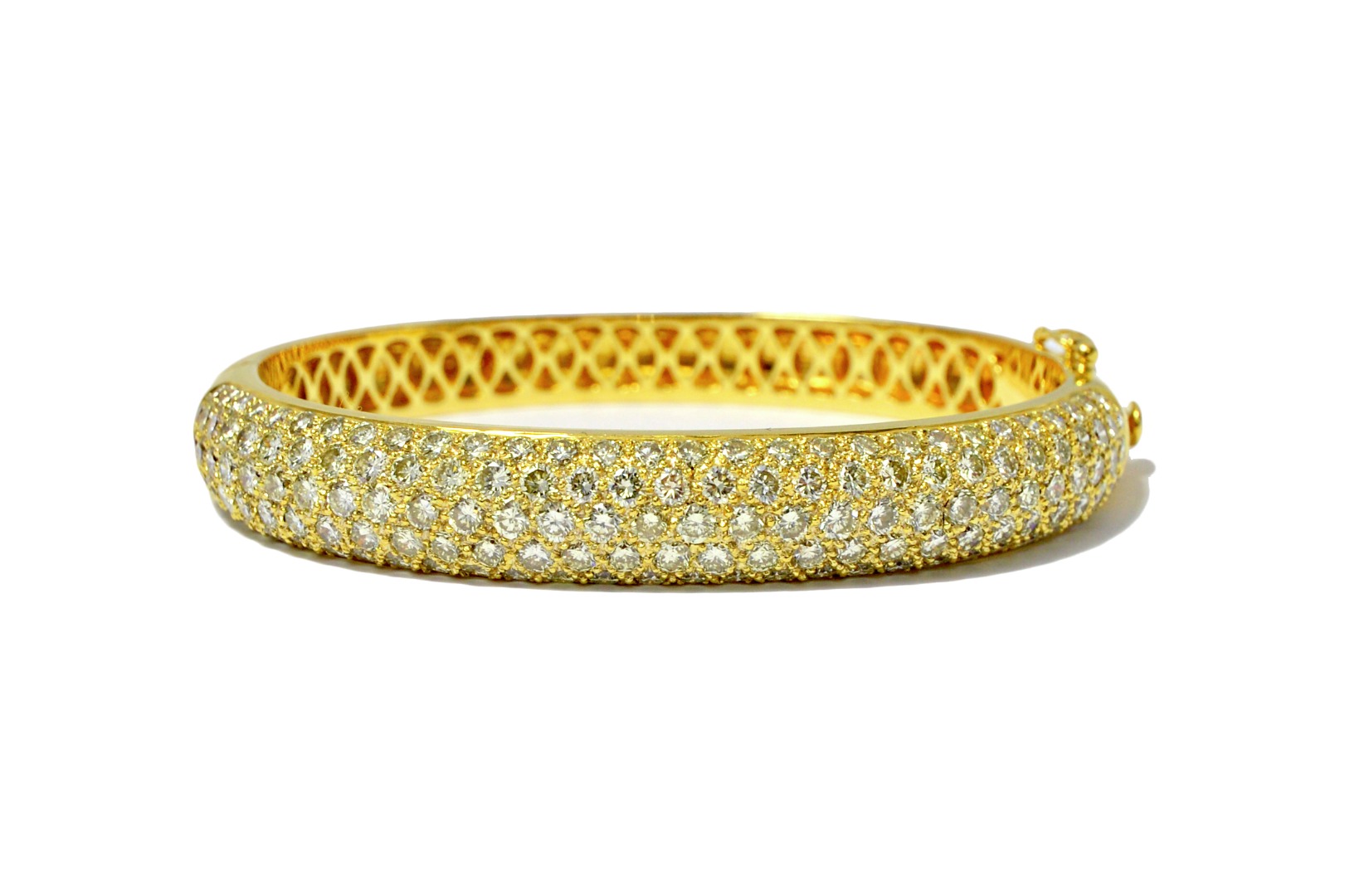 Appraisal: A gold and diamond set oval hinged bangle the curved