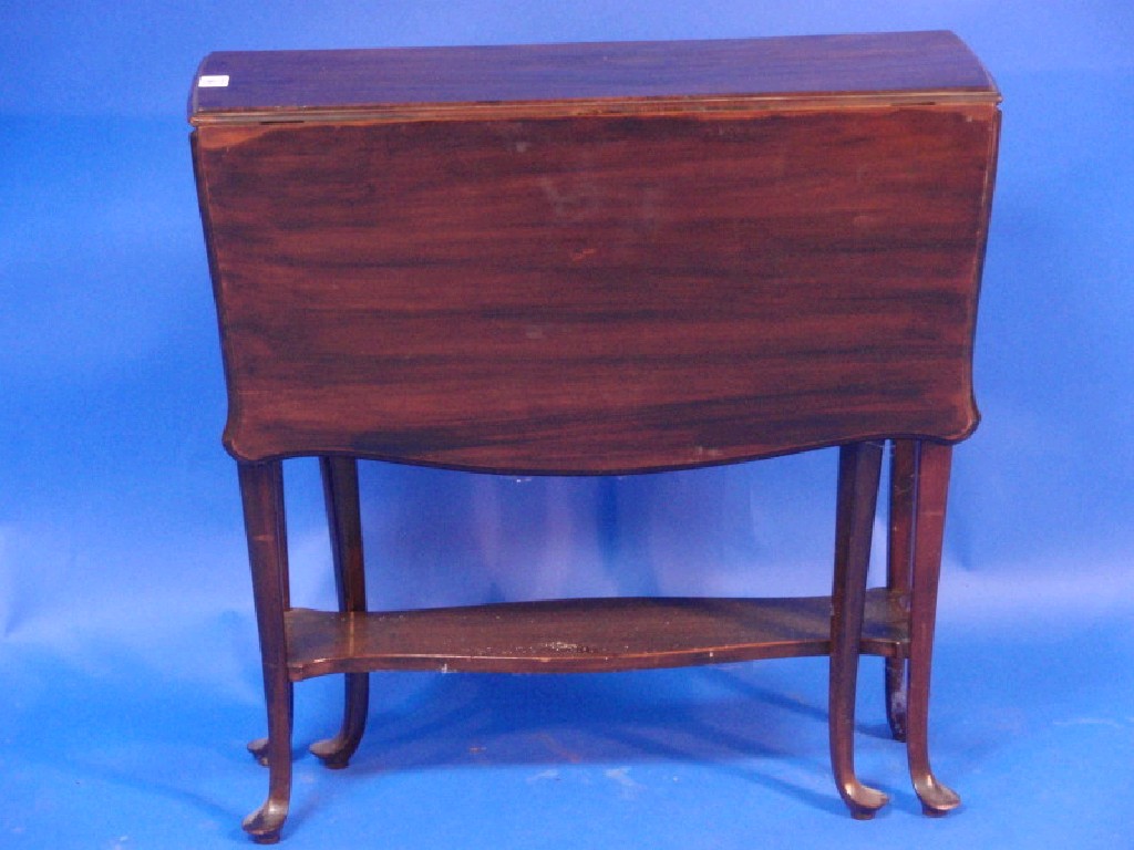 Appraisal: An Edwardian mahogany Sutherland table of serpentine form with club