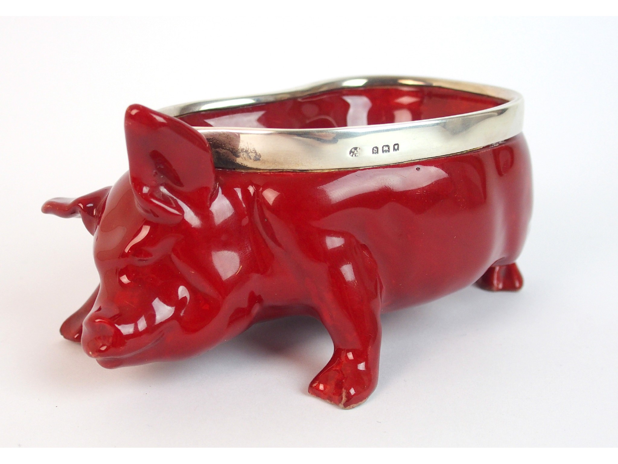 Appraisal: A Royal Doulton flambe novelty pigthe character red glaze pig