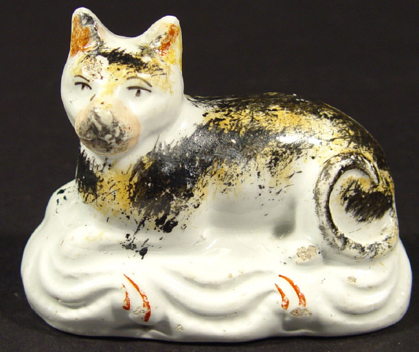 Appraisal: Victorian Staffordshire cat seated on a cushion with hand painted