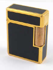 Appraisal: A lacquer and gold plate cigarette lighter by S J