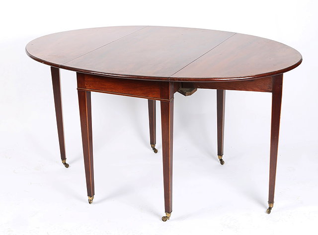 Appraisal: A GEORGE III MAHOGANY OVAL DROP LEAF SUPPER TABLE with