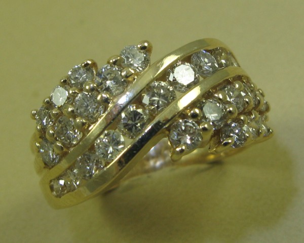 Appraisal: DIAMOND AND FOURTEEN KARAT GOLD RING set with round-cut diamonds