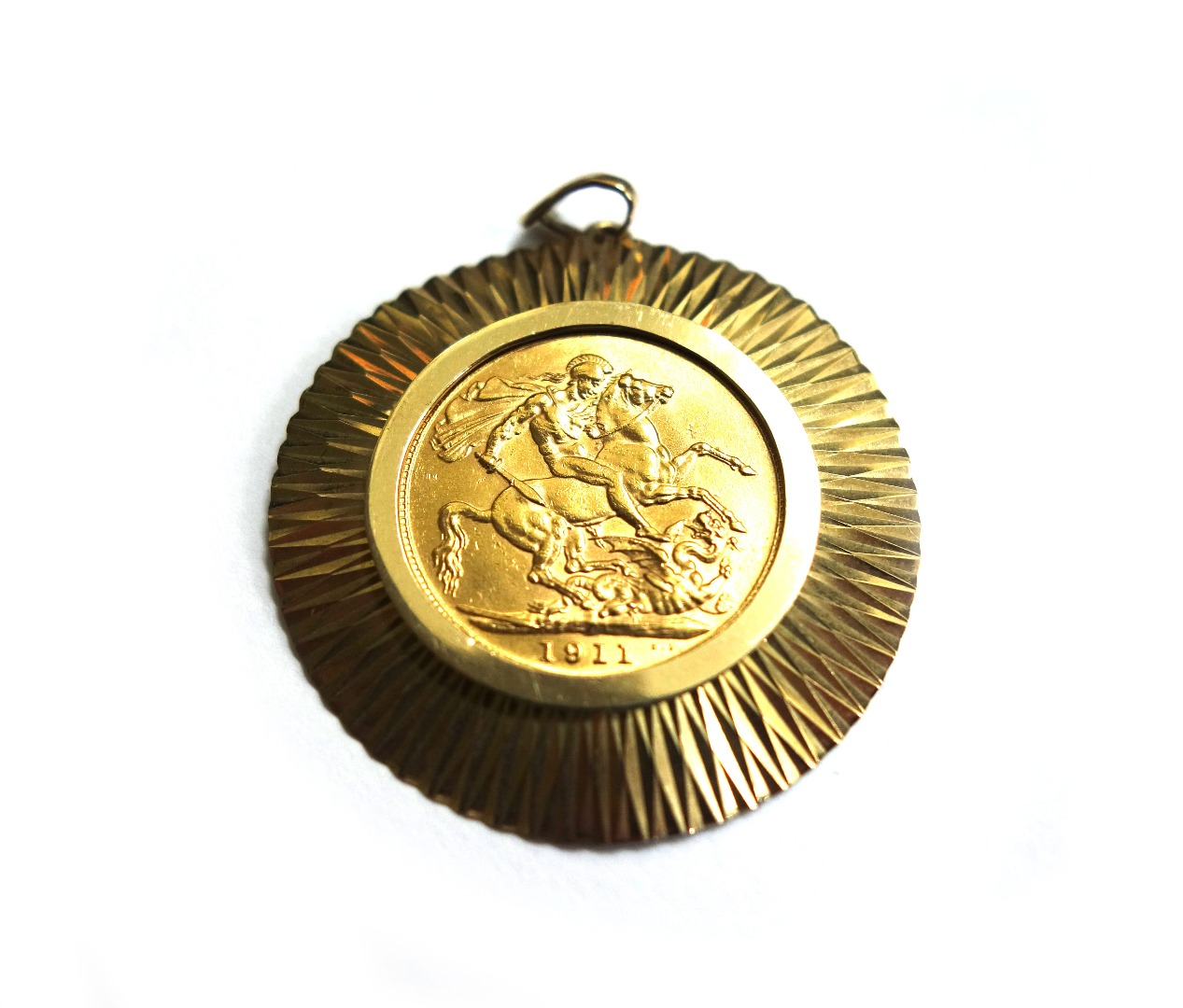 Appraisal: A sovereign loosely mounted in a ct gold pendant hallmarks