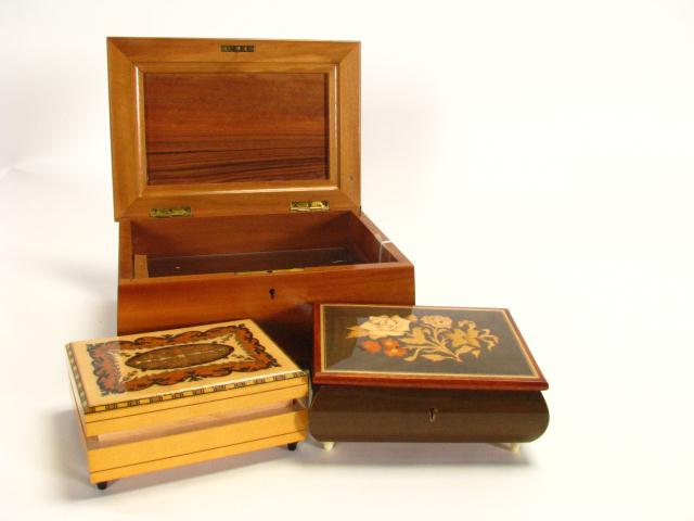 Appraisal: Group of three dresser top music boxes all th century