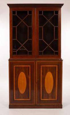 Appraisal: An Edwardian mahogany bookcase the two glazed doors below inlaid