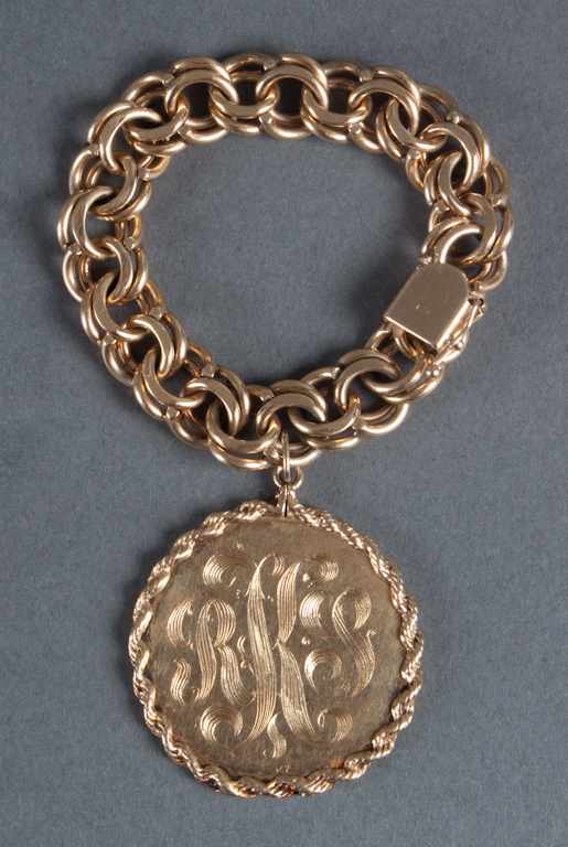 Appraisal: K gold bracelet with a monogrammed charm bracelet in length