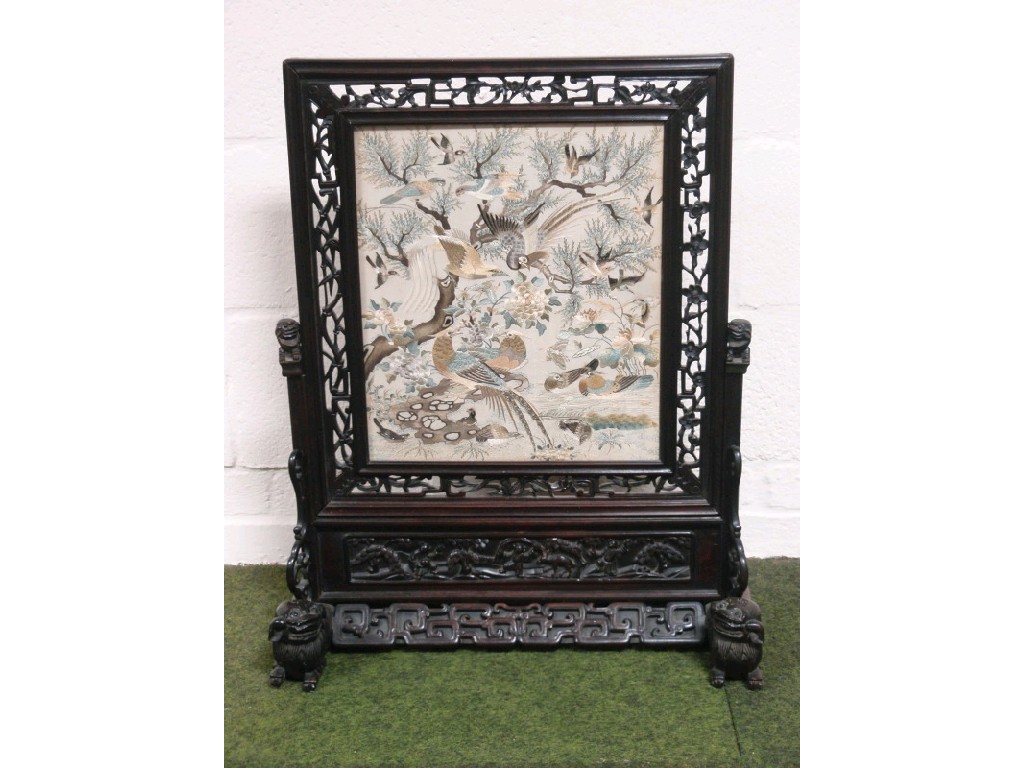 Appraisal: A Chinese carved rosewood screen with openwork framing around a