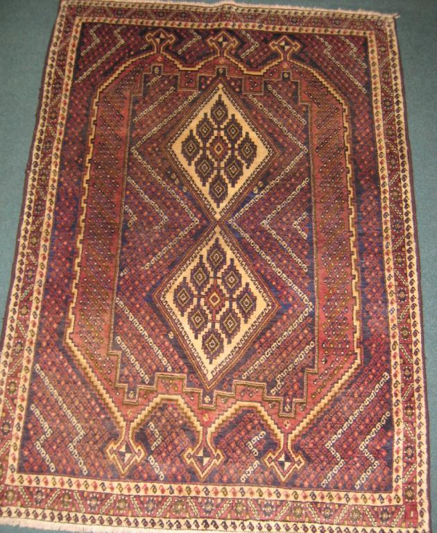 Appraisal: A bordered Ashfar Rug with double medallion and arrowheads in