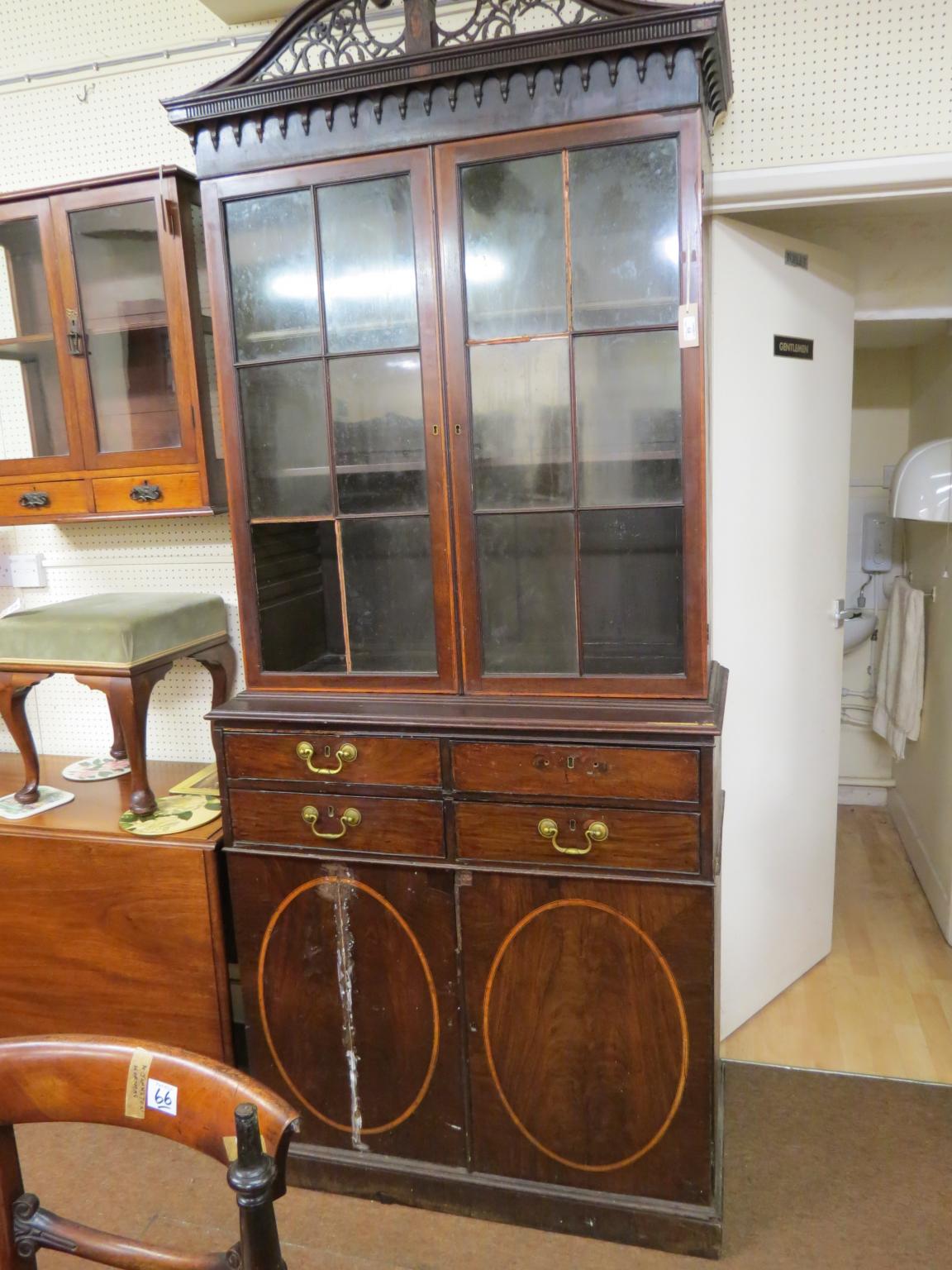 Appraisal: A George III inlaid mahogany bookcase elaborately pierced swan-neck pediment