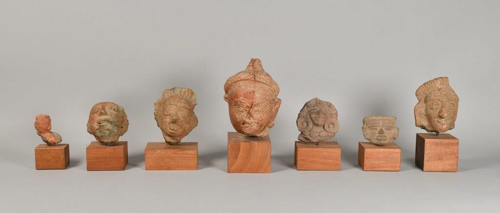 Appraisal: Group of Meso American carved stone heads Largest one has