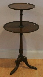 Appraisal: A two tier table on a turned pedestal on three