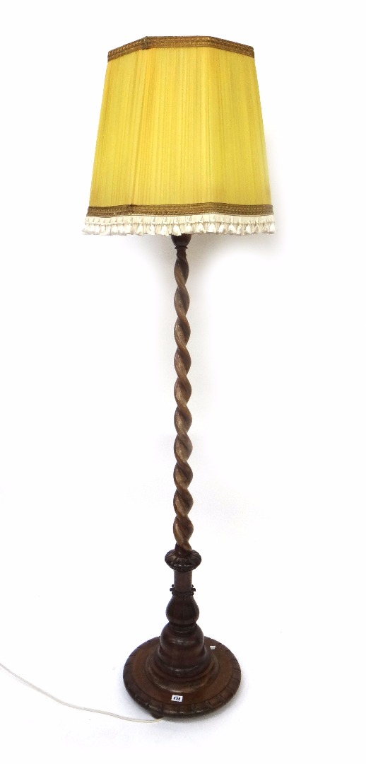 Appraisal: A walnut spiral column standard lamp first half th century