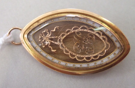 Appraisal: A Georgian gold and white enameled glazed oval pendant brooch