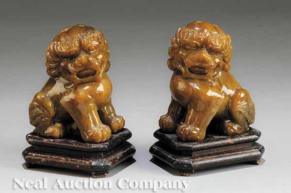 Appraisal: A Pair of Chinese Carved Hardstone Figures of Guardian Lions