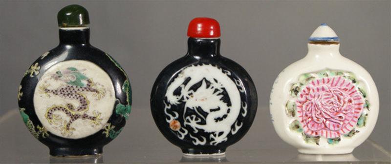 Appraisal: porcelain purse form snuff bottles black with enameled dragon decoration