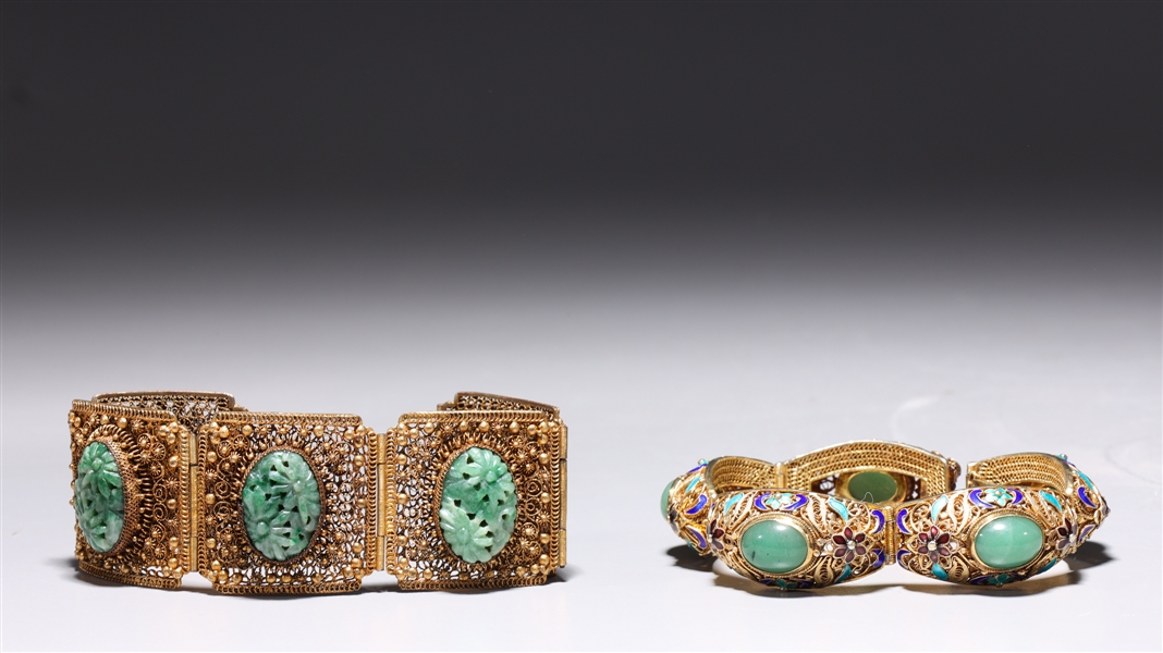 Appraisal: Two Chinese gilt silver bracelets each with jade cabochons and