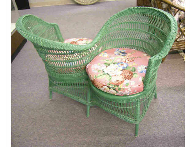 Appraisal: Early th century wicker tete-a-tete with two floral upholstered seat