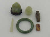 Appraisal: A hardwood box containing five green hardstone Chinese items including