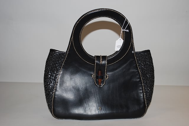 Appraisal: Black leather handbag with woven detail circle handles handmade front