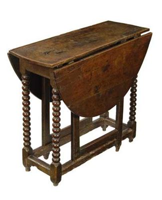 Appraisal: An oak gateleg table the oval drop leaf top on