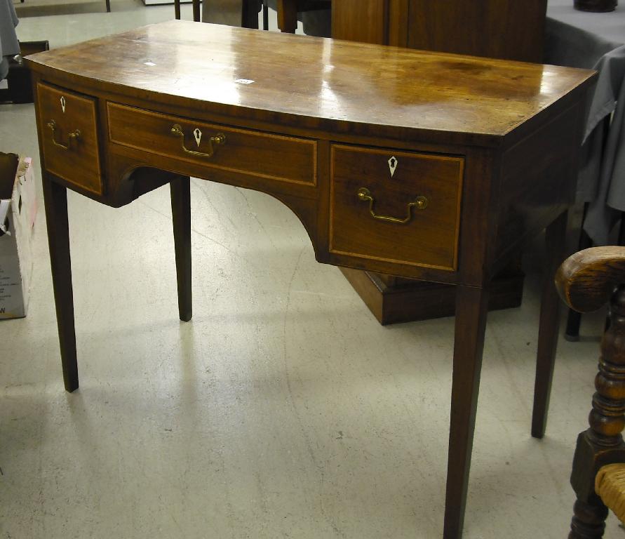 Appraisal: Regency mahogany bowfronted and satinwood banded side table the frieze