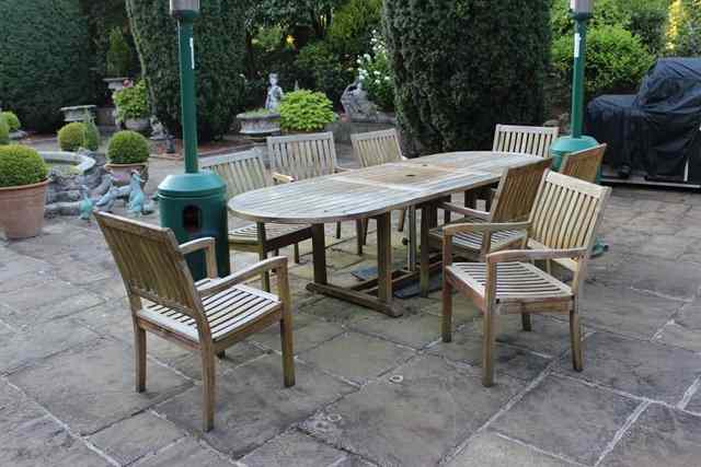 Appraisal: A TEAK EXTENDING GARDEN TABLE with 'D' shaped ends and