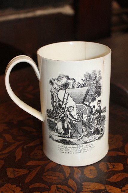 Appraisal: AN ENGLISH CREAMWARE TANKARD bat printed with two satirical scenes