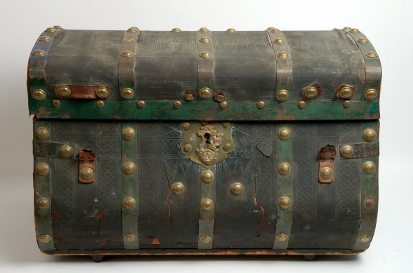 Appraisal: Trunk covered in tooled leather and heavy brass tacks ornate