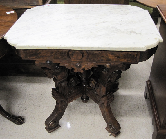 Appraisal: VICTORIAN MARBLE-TOPPED WALNUT LAMP TABLE Renaissance Revival American c having