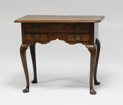 Appraisal: An th Century oak three-drawer side table on cabriole legs