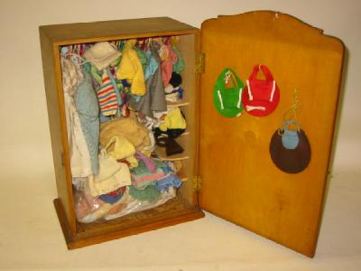 Appraisal: A plywood doll's wardrobe high containing a large collection of