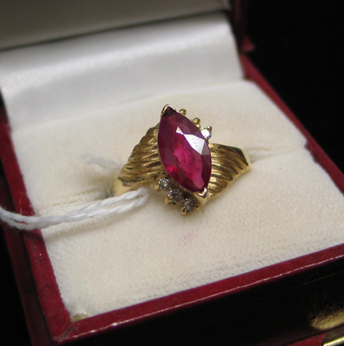 Appraisal: RUBY DIAMOND AND FOURTEEN KARAT GOLD RING with a marquise-cut