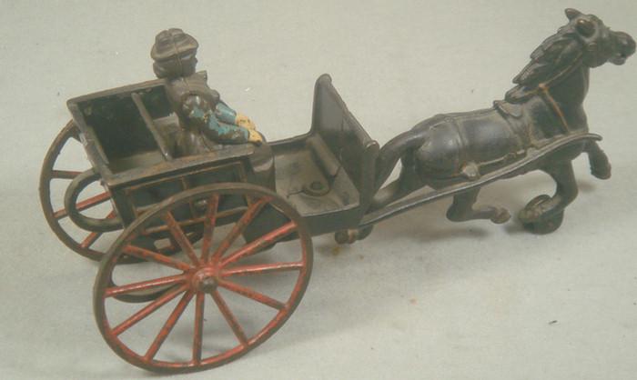 Appraisal: Cast iron toy horse drawn cart with removable lady driver