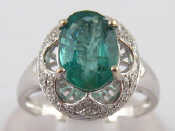 Appraisal: A white metal tests carat gold emerald and diamond ring