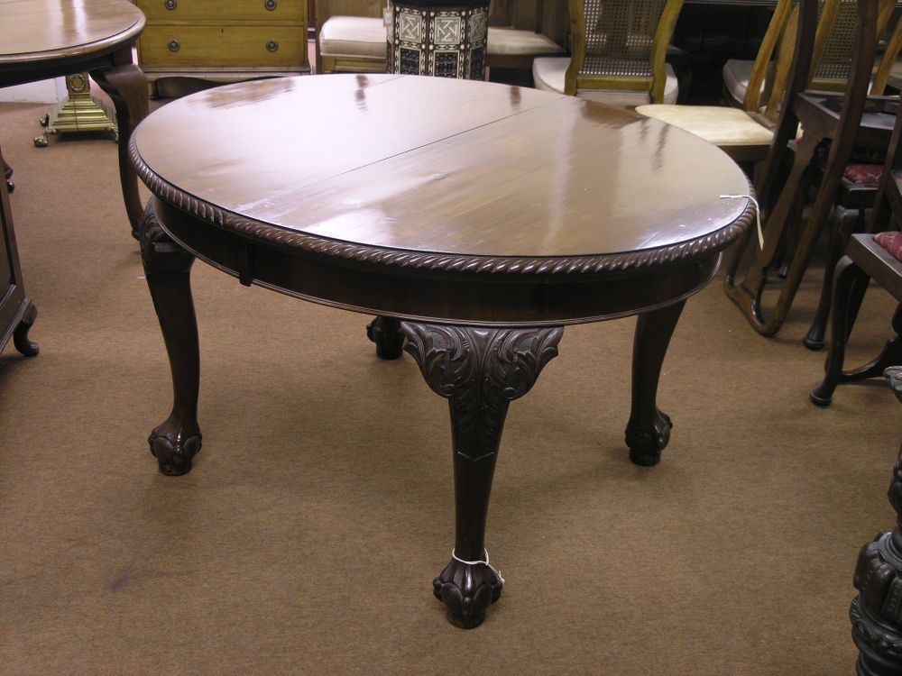 Appraisal: A George V oval extending mahogany dining table with extra