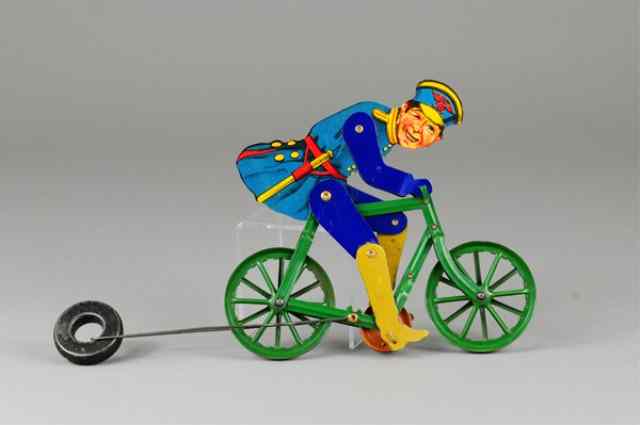 Appraisal: POLICEMAN ON BICYCLE STRING TOY Lithographed tin die cut Police